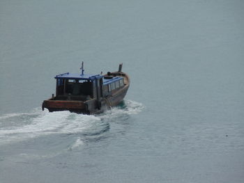 Boat sailing in sea against sky