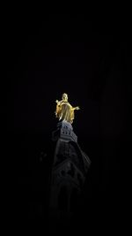 Low angle view of statue of liberty against sky at night