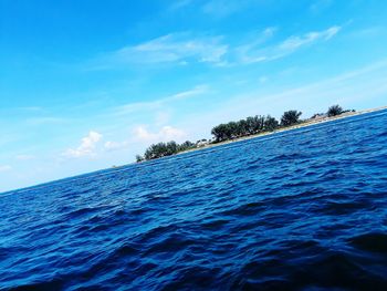 Surface level of swimming pool against blue sky