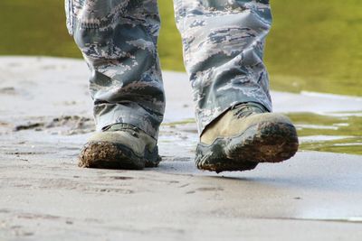 Low section of man standing on ground