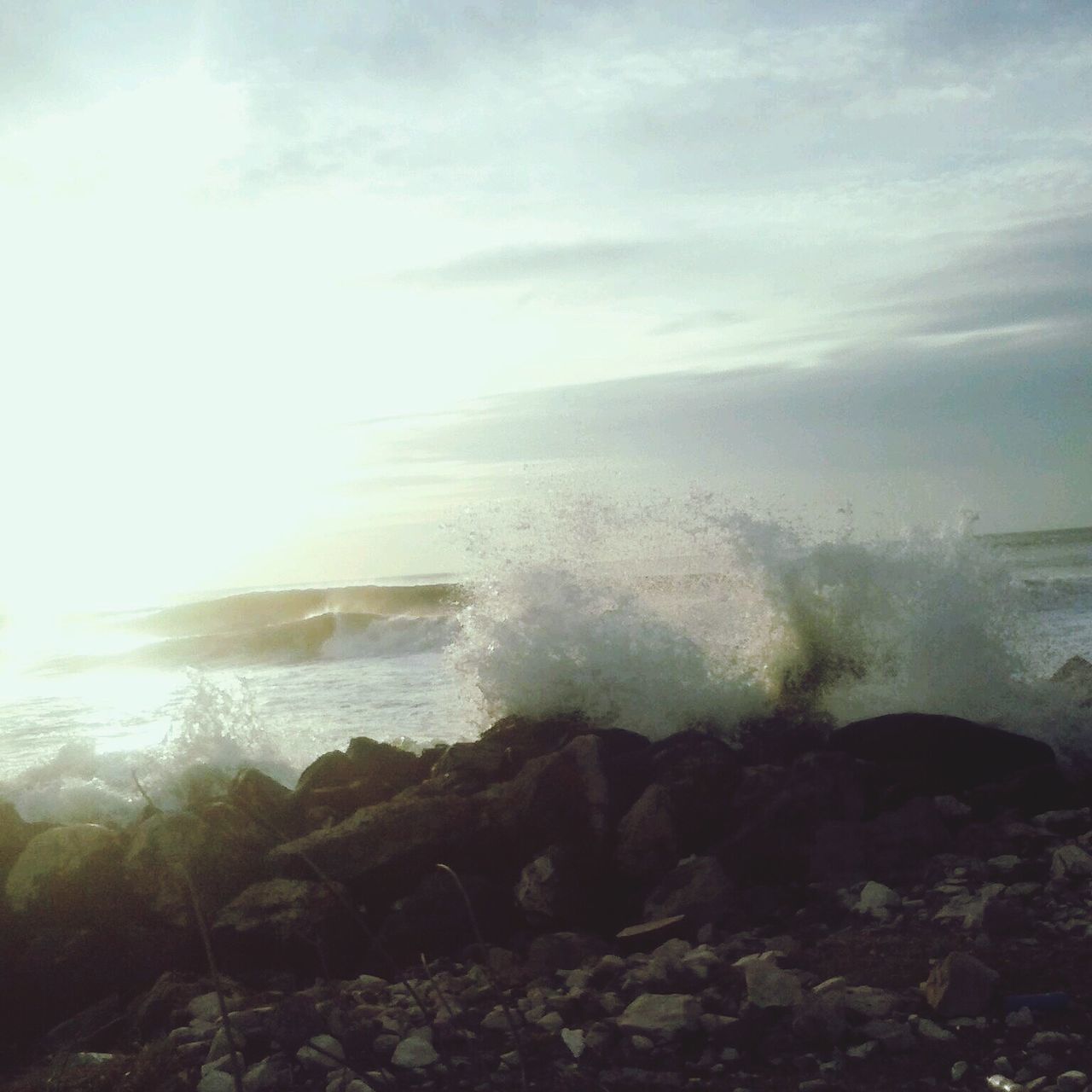 sea, water, horizon over water, scenics, sky, beauty in nature, beach, rock - object, tranquil scene, shore, wave, tranquility, nature, cloud - sky, surf, idyllic, motion, rock formation, sunlight, sun