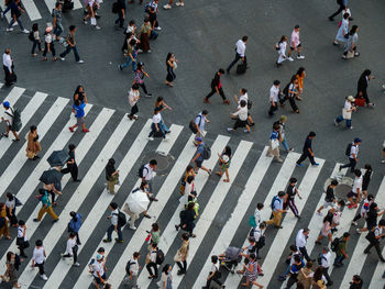 High angle view of people crossing road