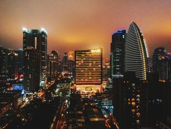 View of skyscrapers lit up at night