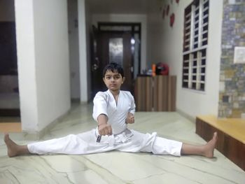 Boy sitting on bed at home