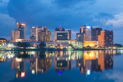 Reflection of illuminated buildings in city at night