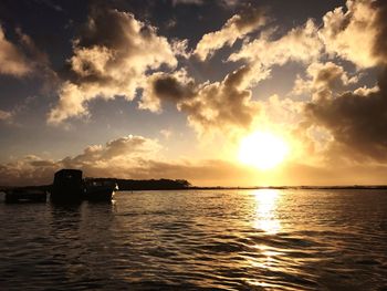 View of sea against cloudy sky during sunset