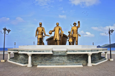 Low angle view of statue against blue sky