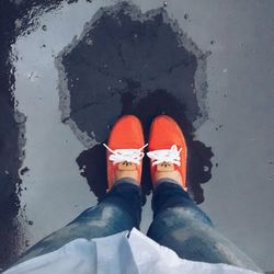 Low section of woman standing on tiled floor