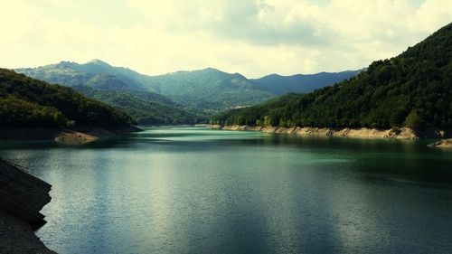 Scenic view of lake and mountains against sky