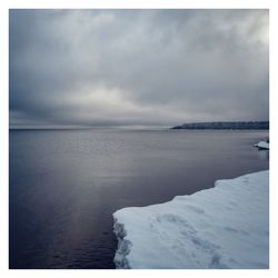 Scenic view of sea against sky during winter