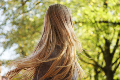 Rear view of woman against tree