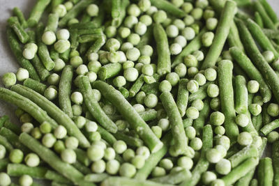 Heap of frozen green beans and peas