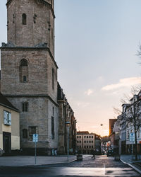 Street amidst buildings against sky in city