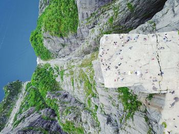 High angle view of people on rocky cliff