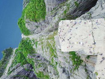 High angle view of people on rocky cliff