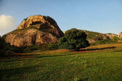 Scenic view of rocks on field against sky