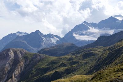 Scenic view of mountains against cloudy sky