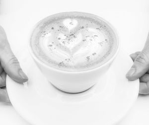 Close-up of hand holding coffee cup