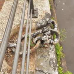 High angle view of rusty metal pipe on field