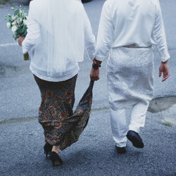 Low section of couple standing on street