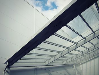 Low angle view of elevated walkway against sky