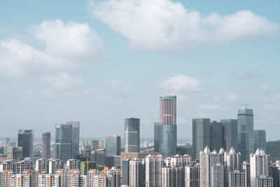 Modern buildings in city against sky