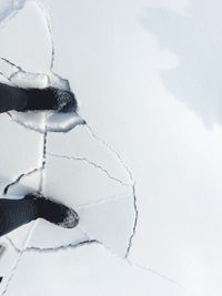 Low section of person standing on snow