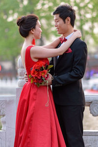 Couple holding red flower