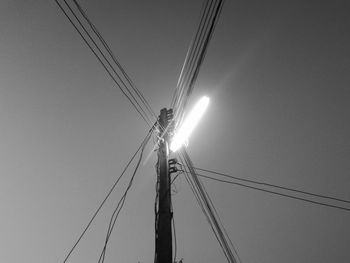 Low angle view of overhead cable car against sky