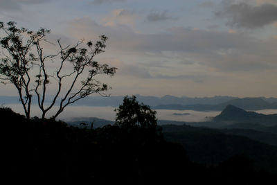 Scenic view of silhouette mountains against sky at sunset