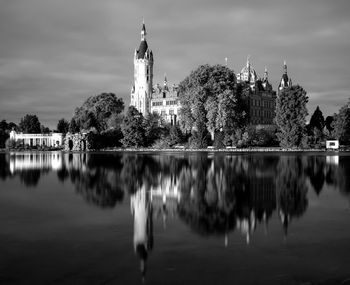 Reflection of trees and buildings in lake