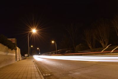 Illuminated road at night during winter