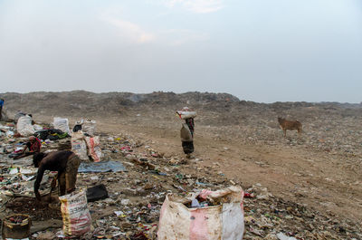 Panoramic view of people on land against sky