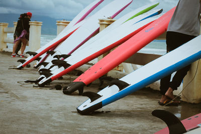 Surfboards leaning on railing at pier