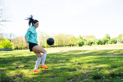 Full length of woman playing on field