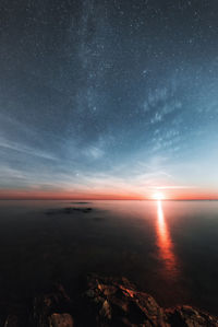 Scenic view of sea against sky at night