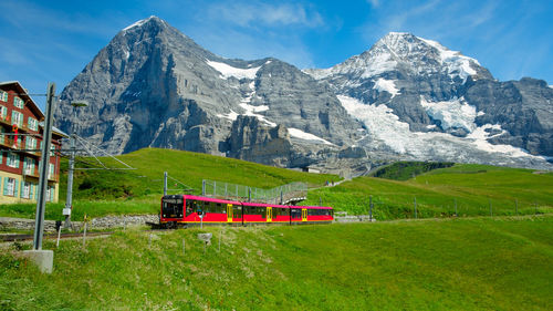 Train by mountains against sky