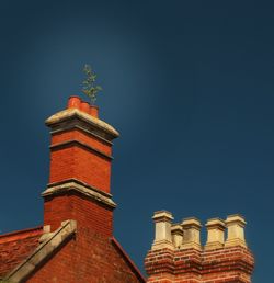 Low angle view of building against clear blue sky