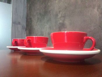 Close-up of red wine glasses on table