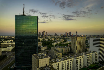 Warsaw, city centre panorama at sunset, business centre 2022. sunset reflected in buildings.