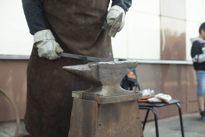Midsection of man working in workshop