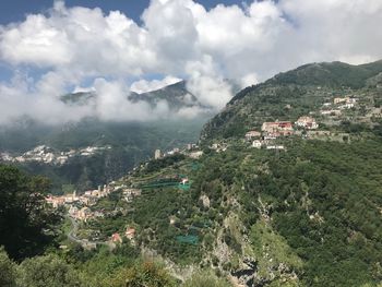 Aerial view of townscape and mountains against sky