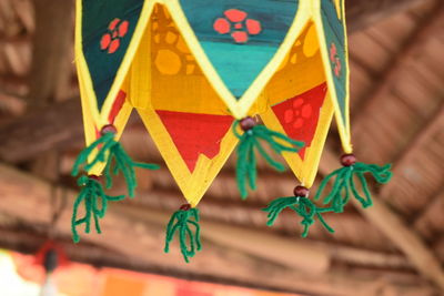 Low angle view of multi colored flags hanging on wood