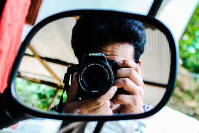 Portrait of man photographing camera