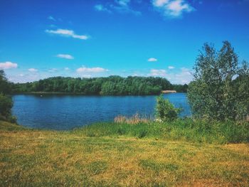 Scenic view of lake against blue sky