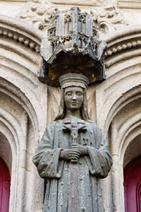 Low angle view of statue against historic building