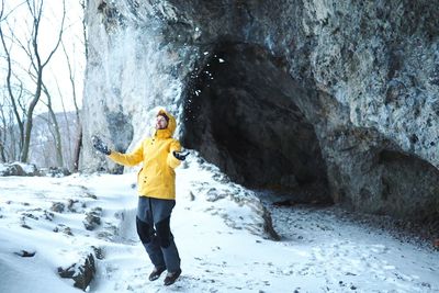 Woman standing on snow covered land