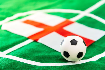 Close-up of soccer ball with flag on field