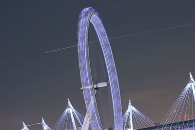 Low angle view of illuminated ferris wheel at night