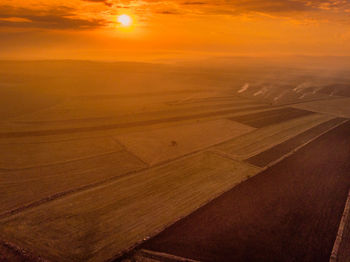 Scenic view of land against sky during sunset